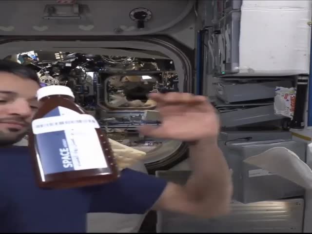 Astronaut Eating Bread And Honey In Space